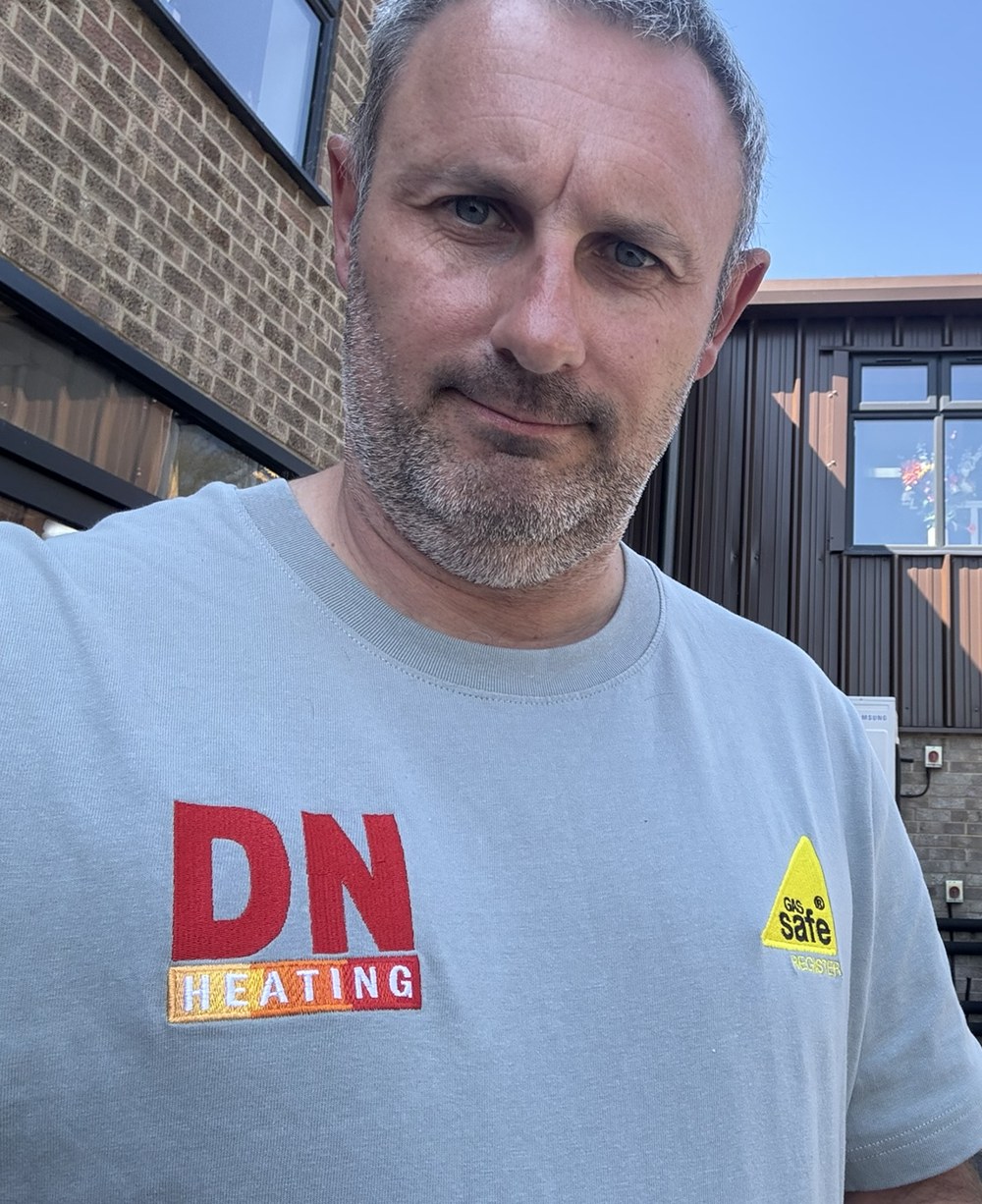 Darren of DN Heating in a DN Heating T-shirt