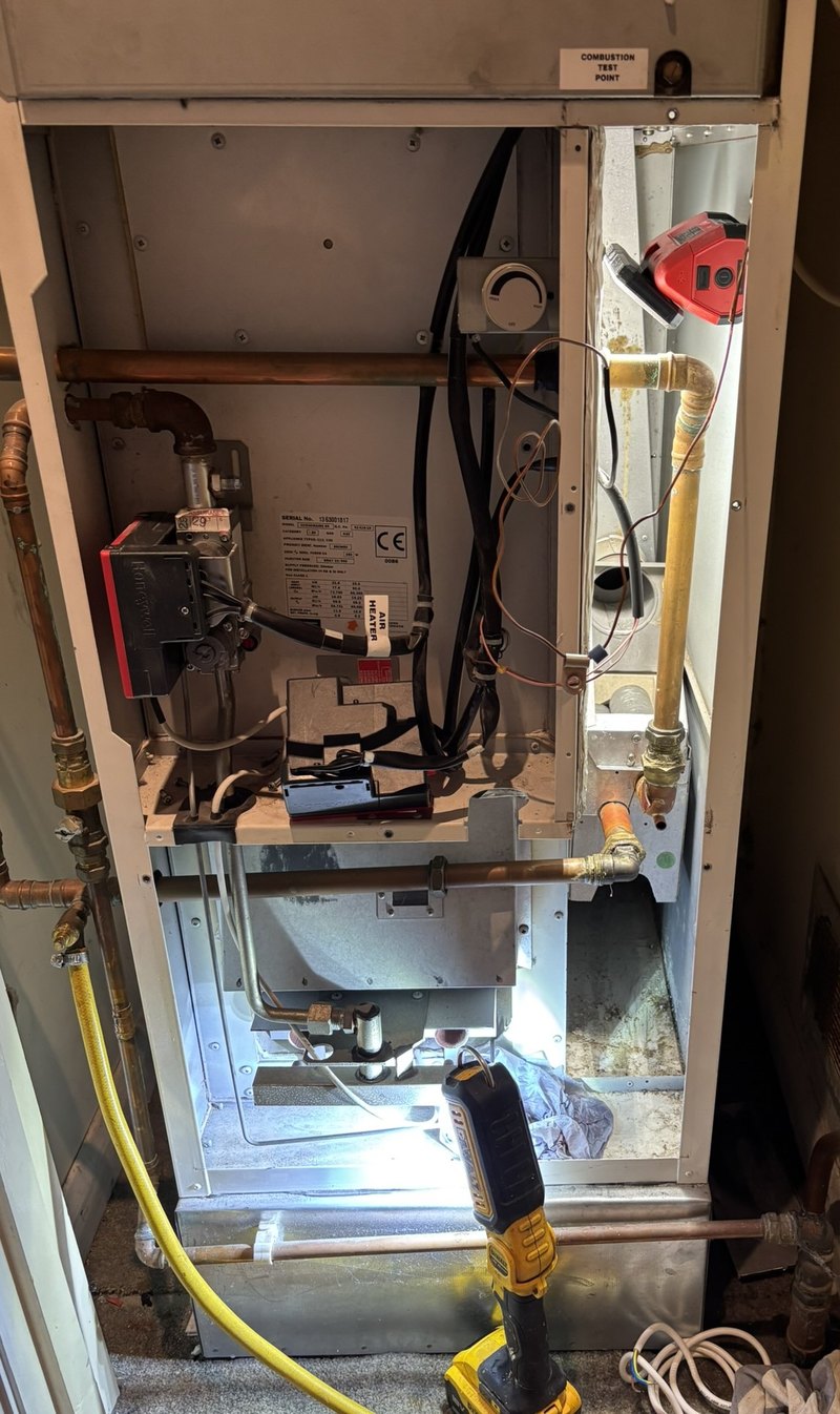 Warm air unit with its covers off during a repair